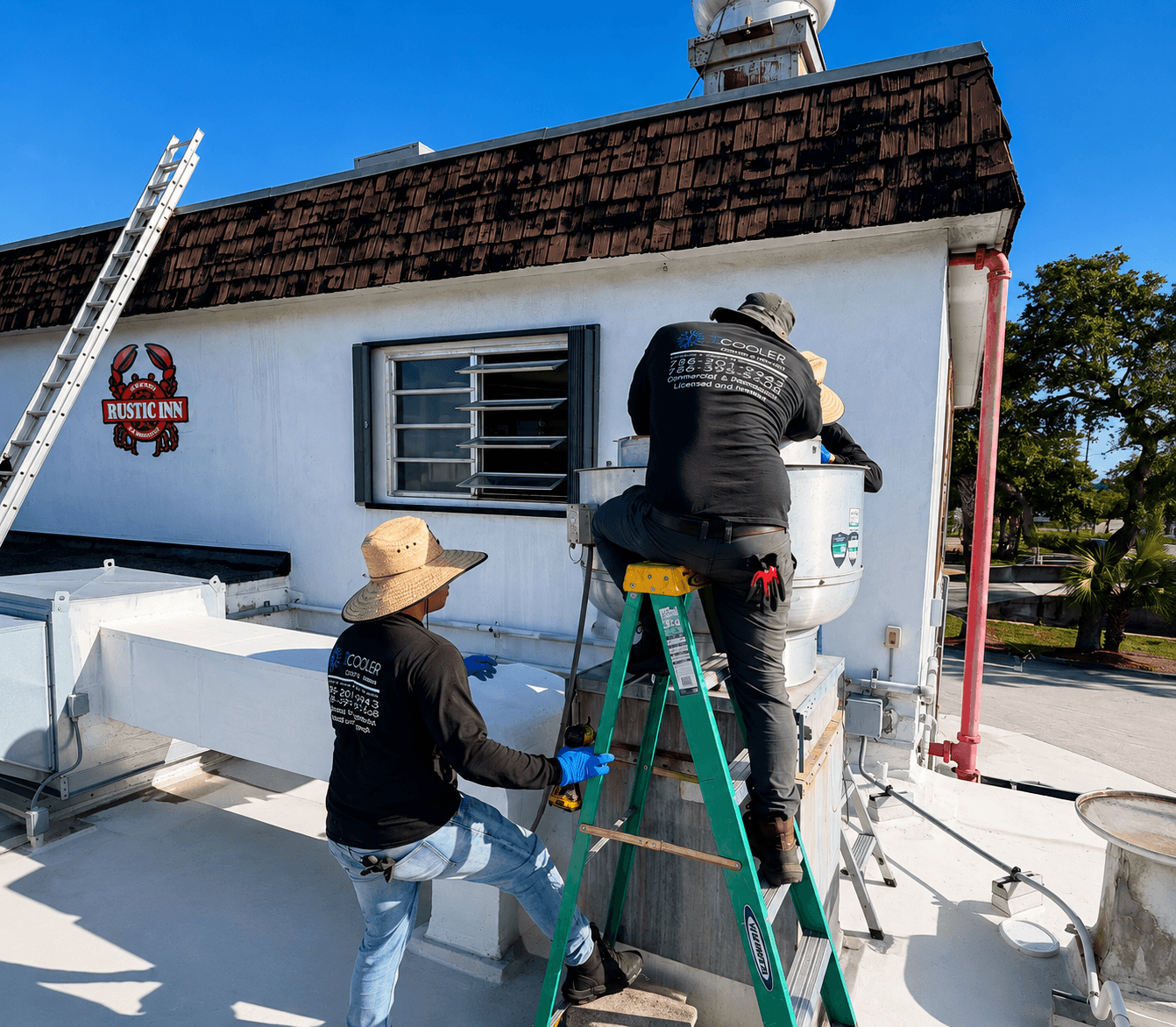 D'Cooler technicians servicing commercial rooftop HVAC equipment